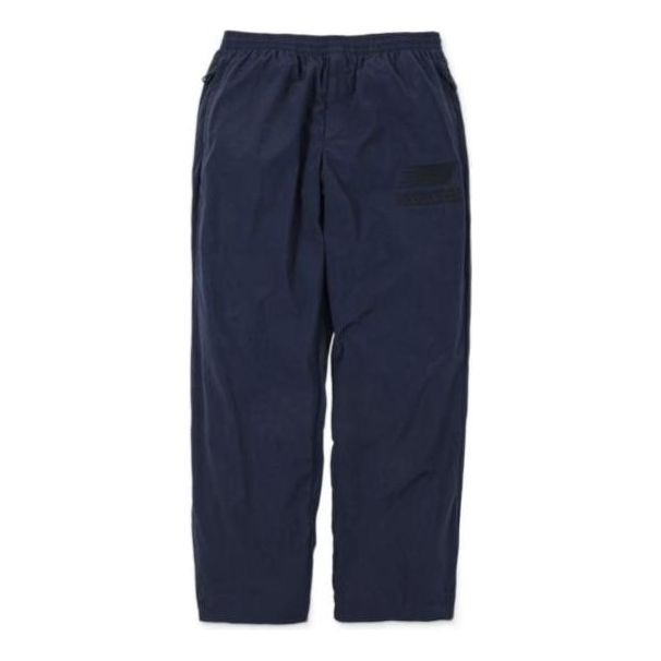 Verryttelyhousut New Balance N.HOOLYWOOD x INVINCIBLE(R) Woven Pants Sininen | AMP22346-PCT